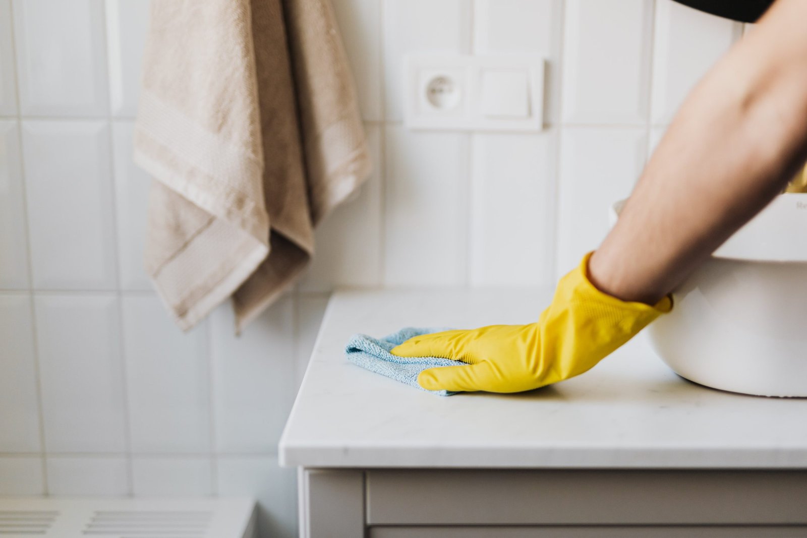 Deep cleaning bathroom counter with rag